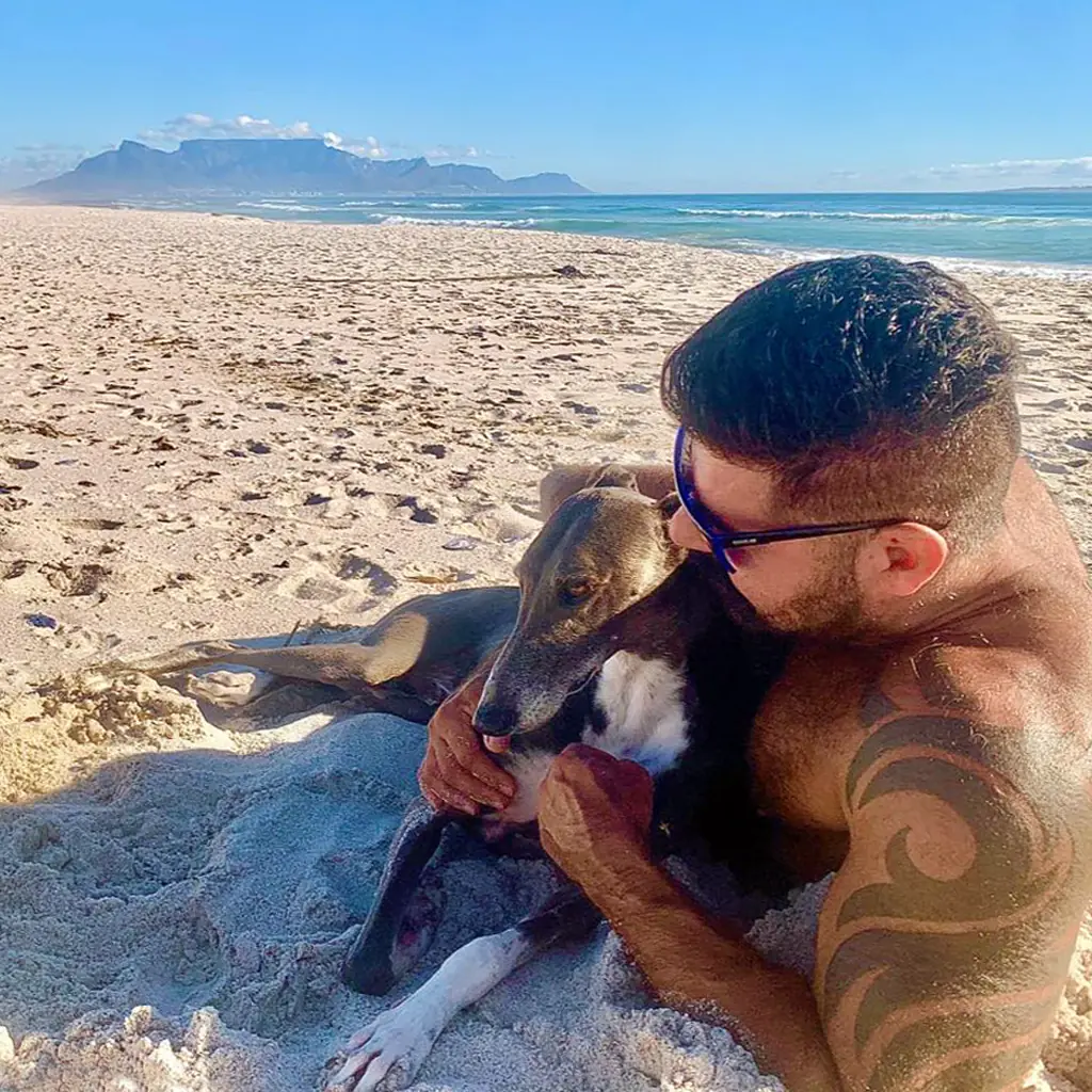 Nutriflex Joint Supplements Is With Tom And His Dog On The Beach In Cape Town Facing Table Mountain